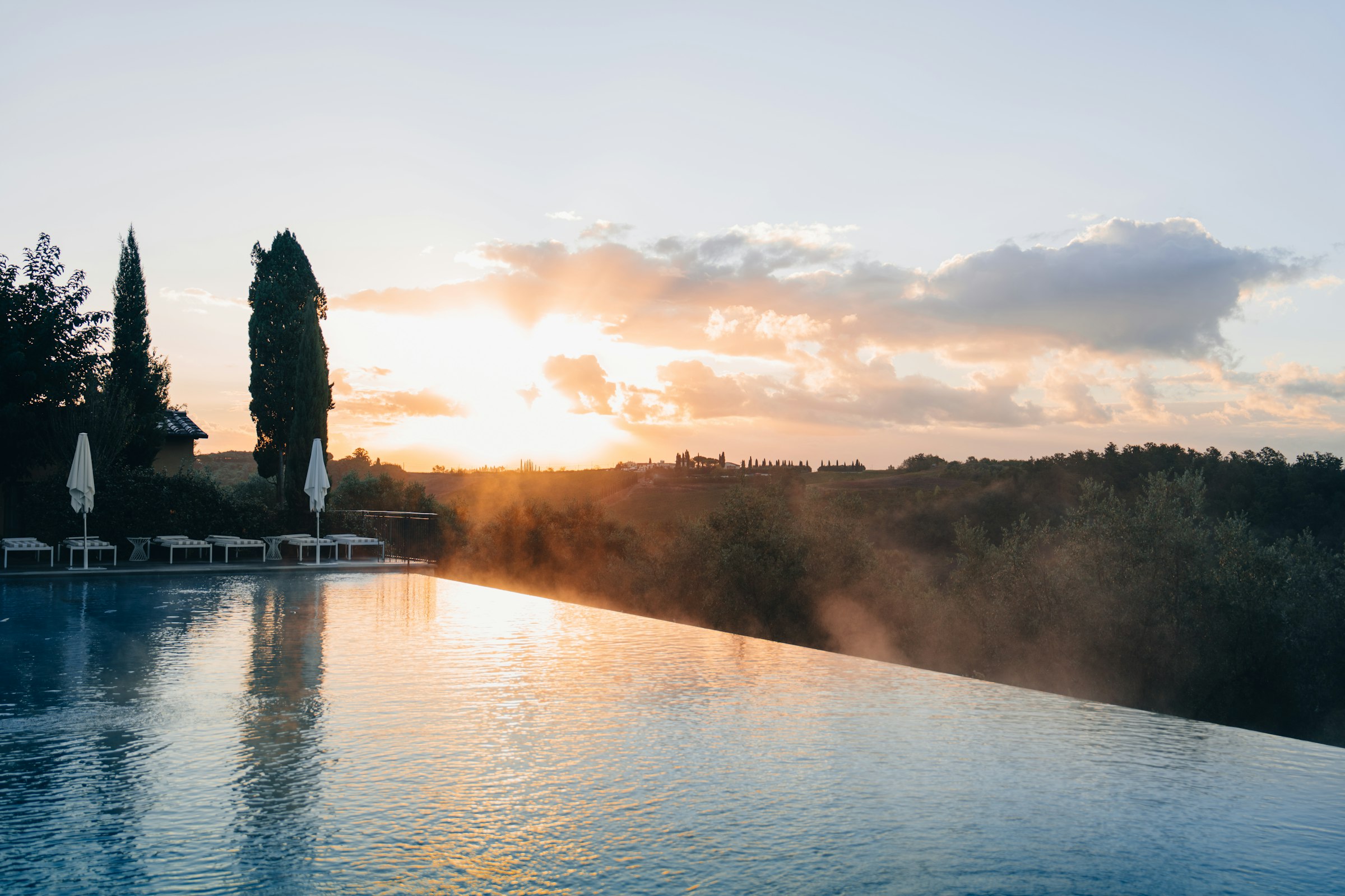 Infinity pool in golden morning mist at first light