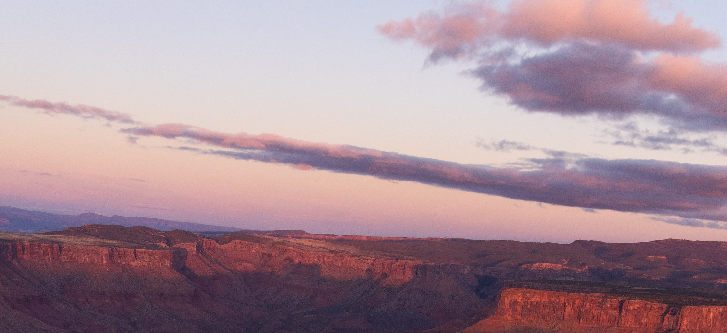Canyon walls and mesas fading into dusk light