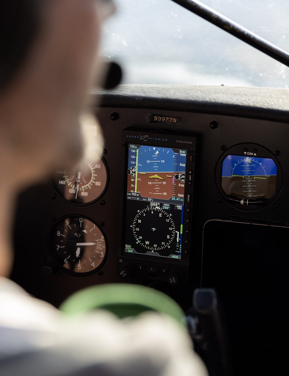 A pilot at the instrument panel of an aircraft
